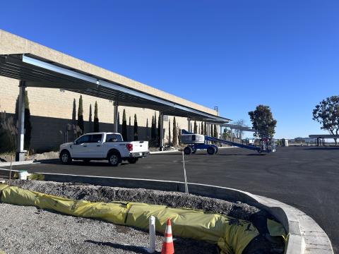 Paved parking lot with solar panel canopies 